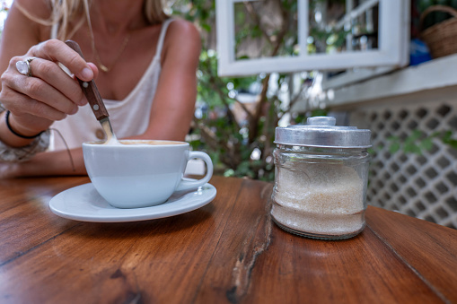 She is enjoying her morning coffee in a garden cafe in Valladolid, Mexico.