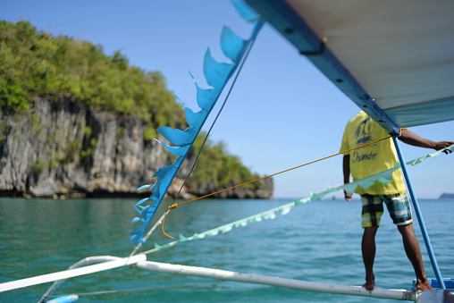 A local Filipino guid man and his colourfull touristic boat.