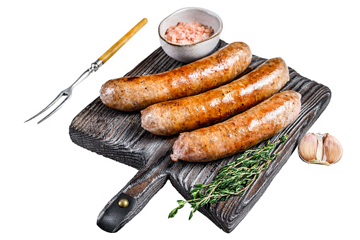Sausages barbecue fried with spices and herbs on a wooden cutting board.  Isolated on white background, Top view