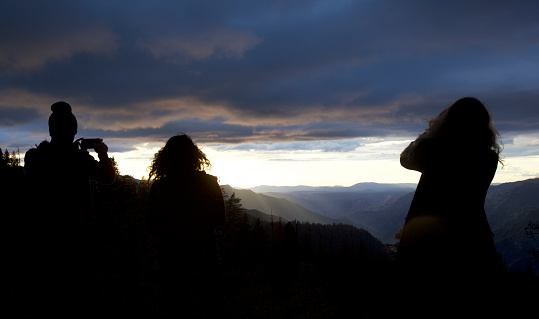 Yosemite National Park, USA - October 19, 2015: Three women experiencing the sunset over Yosemite National Park, Californien, USA.