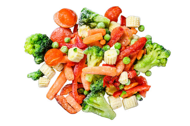 istock Frozen cold sliced Vegetables, broccoli, sweet peppers, tomatoes, carrots, peas and corn.  Isolated on white background, Top view. 1945056457