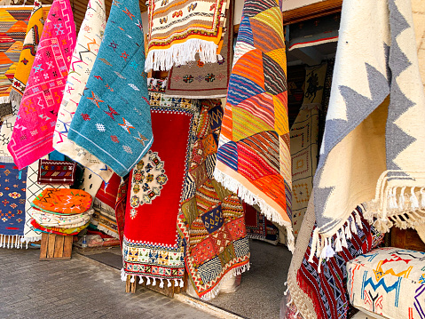 Colorful moroccan carpets with oriental ornaments for sale on a street shop in loudaya's old city of rabat of Morocco. Artistic picture. Beauty world.