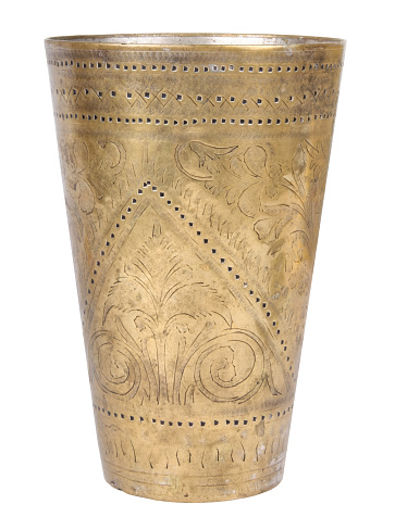 Old handmade brass drinking cup from the oriental space.
