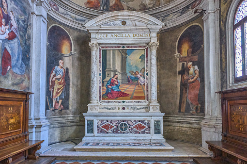 Treviso, Italy - September 13, 2022: Cathedral of St. PeterThe Malchiostro chapel with altarpiece by Tiziano bearing the Latin inscription: here is the Lord's Maid