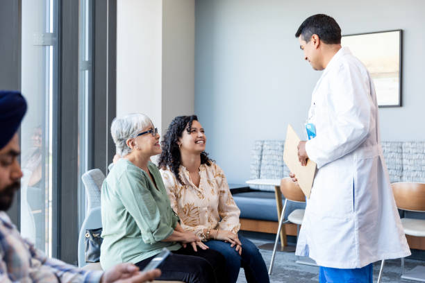istock Male physician talks with his patient and her daughter 1945082951
