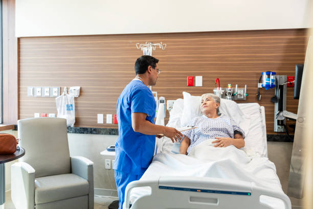 istock Male surgeon talks to his female patient about her treatment plan when she gets released 1945087368