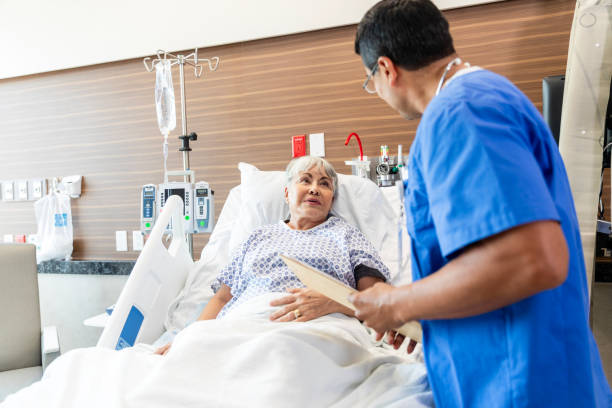 istock Male nurse asks his patient if she needs anything else before he leaves for the day 1945087375