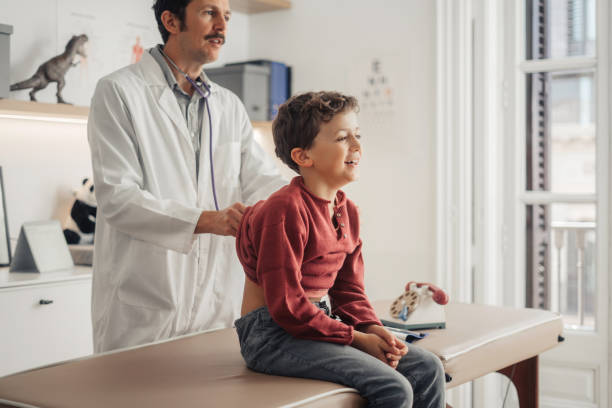 istock Doctor examining young boy 1945090129