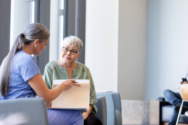 istock Mature female doctor talks to her patient 1945090655