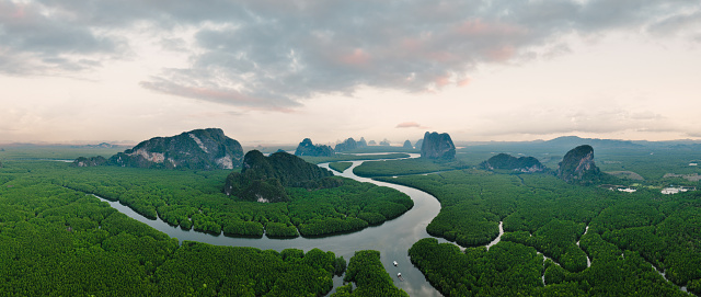 View from above, aerial shot, stunning panoramic view of Ao Phang Nga (Phang Nga Bay) National Park featuring a multitude of limestone formations rising from the sea. Thailand.