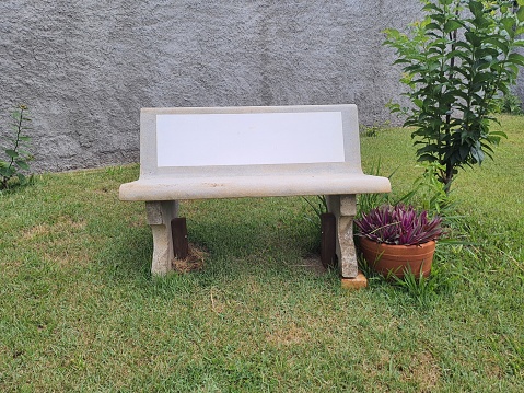 Concrete bench, isolated in a private garden.