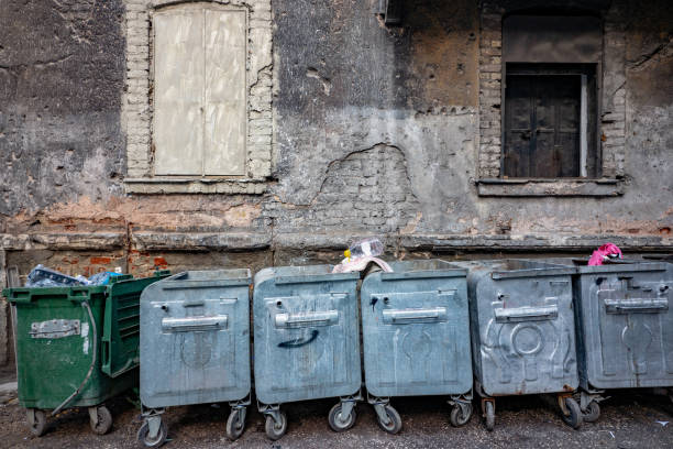istock Garbage containers in front of abandoned house 1945127772