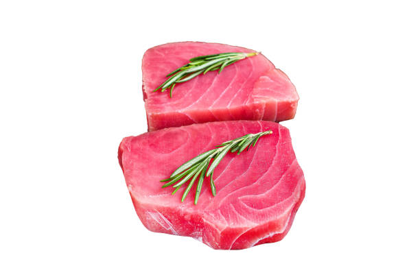 istock Raw tuna steaks on a wooden cutting Board Isolated on white background, Top view. 1945128307