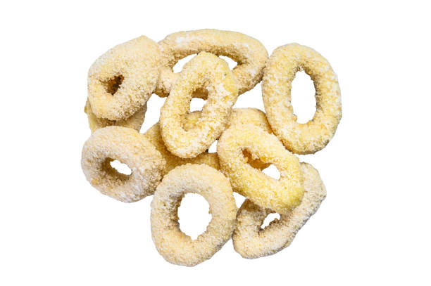 istock Frozen raw squid rings in breadcrumbs.  Isolated on white background, Top view. 1945128325
