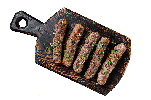 Homamade grilled Lula kebab meat  sausages on a cutting board.  Isolated on white background, Top view