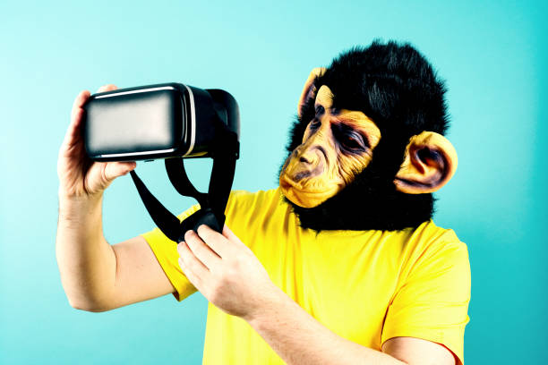 istock Person in Monkey Mask Examining VR Headset 1945131010