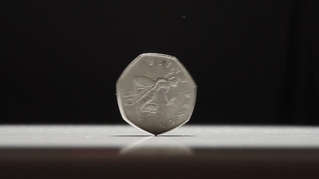 British 50 Pence Coin Spinning on Table