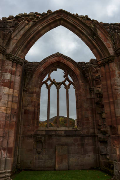 East window: part of the ruins of Melrose Abbey, dedicated to \nSt. Mary, a monastery of the Cistercian order, Scottish Borders, UK. Today the abbey is maintained by Historic Environment Scotland as a scheduled monument.