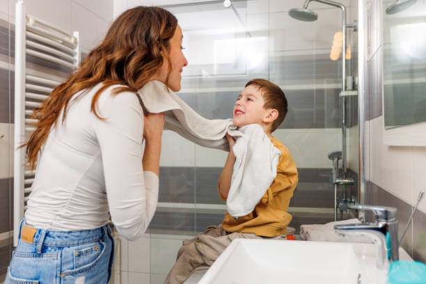 istock Mother And Her Son Drying Up Face With Towel 1945170348