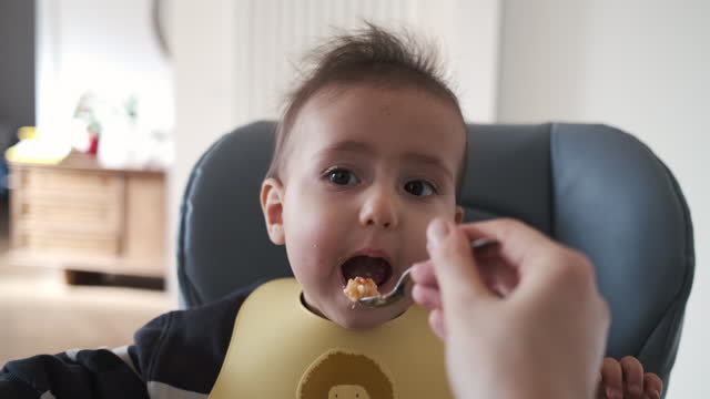 A cute baby is eating for lunch