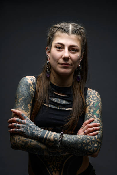 istock Tattooed girl studio portrait on gray background 1945184893