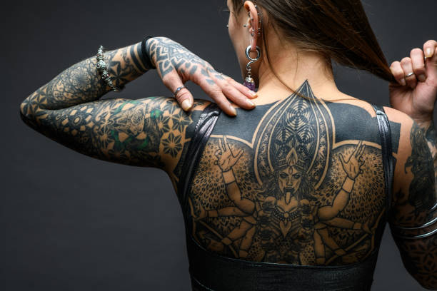 istock Tattooed girl studio portrait on gray background 1945186988