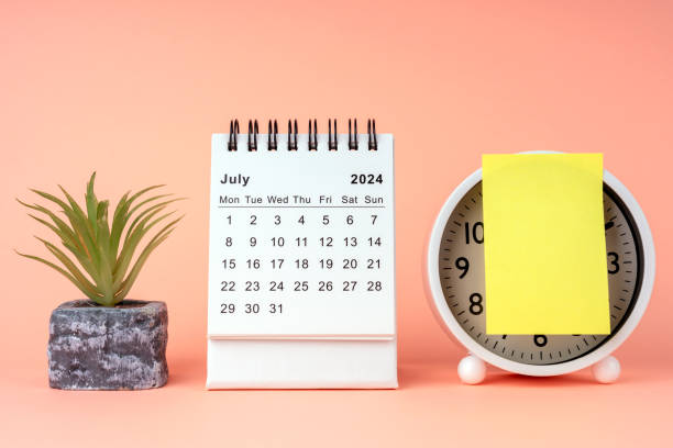 istock July 2024 desk calendar with adhesive note and alarm clock 1945204214