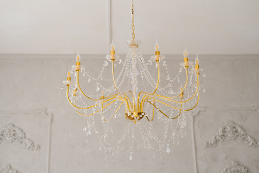 Gold crystal chandelier in a classic style in the interior of the house