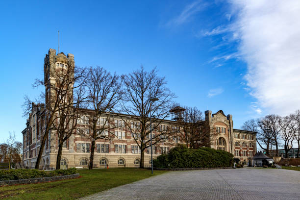 istock Empty esplanade with old main building of former Waterschei mine in background 1945222909