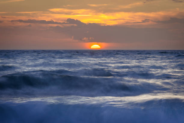 Landscape with dramatic sky over by sea.