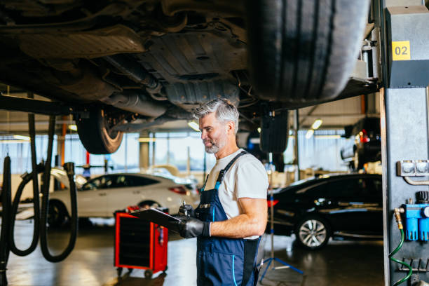 istock Car diagnostics. Auto service. Skillful professional middle age master performs maintenance, oil change, computer diagnostics, replacement of auto parts, repair of brake system. 1945241851