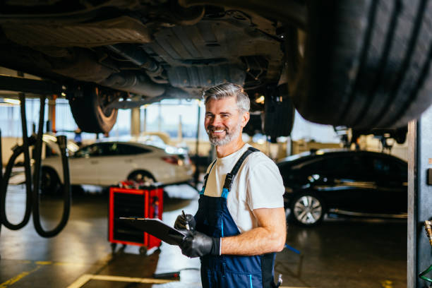 istock Happy smiling handsome grey hair mechanic at work in his garage. 1945241853