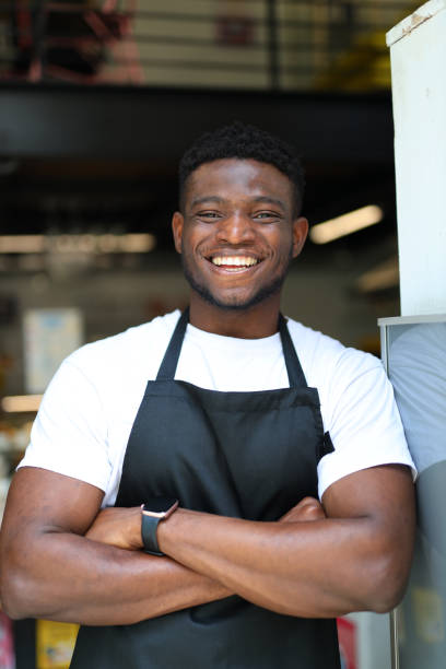 Confident and successful entrepreneur, with a warm smile, standing in a modern shop setting
