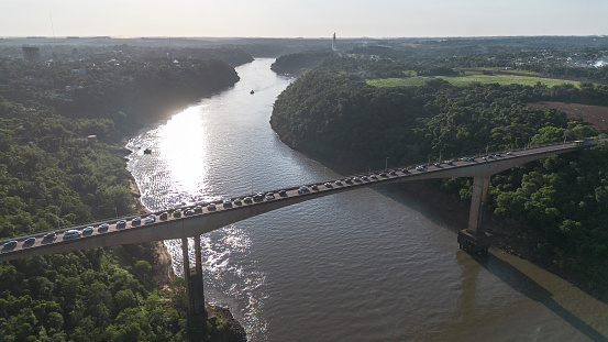 Cars in a traffic jam on a bridge that crosses the river. The International Friendship Bridge, which connects the cities of Foz do Iguaçu (BRA) and Puerto Iguazú (ARG). Heavy traffic at the customs to cross to the Argentine side