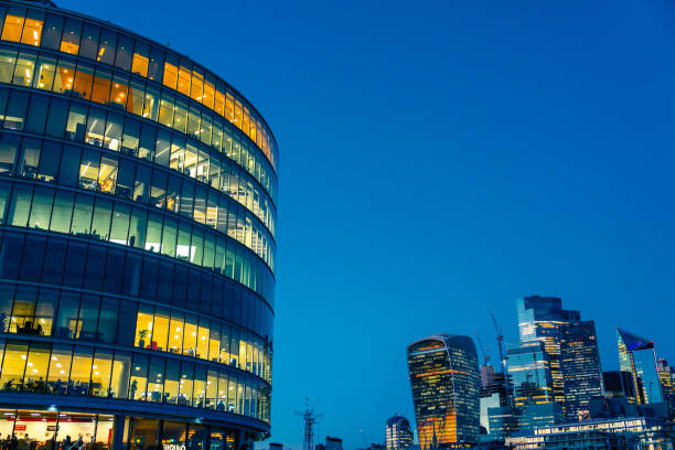 istock Illuminated office buildings in London at Night 1945288718