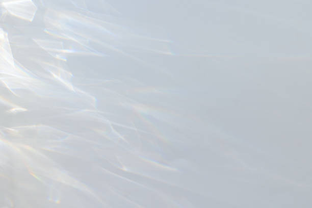 istock Crystal prism rainbow light refraction texture on white background overlay 1945289250