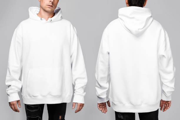 istock Front and back views of a man wearing a white, oversized hoodie with blank space, ideal for a mockup, set against gray background. 1945302404