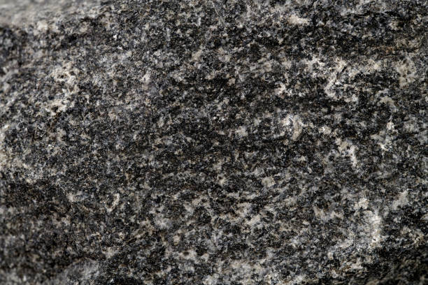 istock Stone texture abstract background. Close up natural dark mineral rock backdrop 1945316739