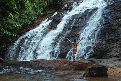 Beautiful Young Woman in Swimsuit Posing Near Ton Phrai, Waterfall.