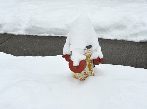 Closeup of a fire hydrant covered after a heavy snowfall.
