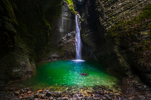 Picturesque waterfall in the Soca valley, Slovenia. Kozjak waterfall in the deep mountain canyon in Triglav national park.