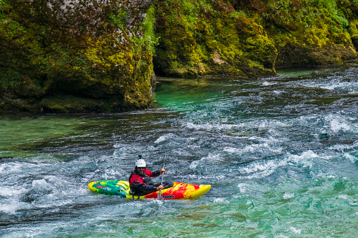 2018-07-01 Kobarid, Slovenia. Kayaker in the fast waters of Soca river. Sport outdoor activities in Soca valley.