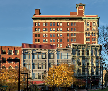view of downtown Binghamton buildings at sunset golden hour (historic architecture including the press building on court street and chenango) autumn colors at dusk small town, city upstate new york NY