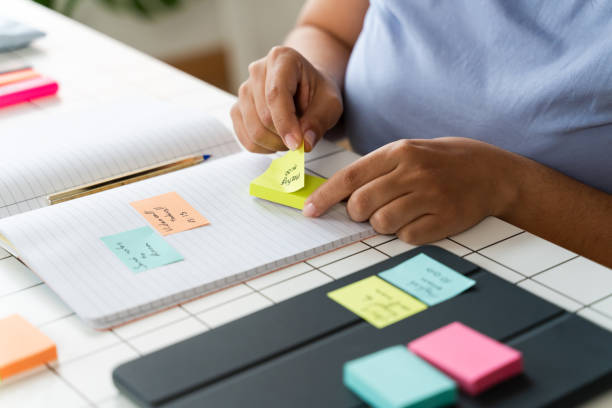 istock Person Organizing Ideas With Sticky Notes on Paper 1945369375