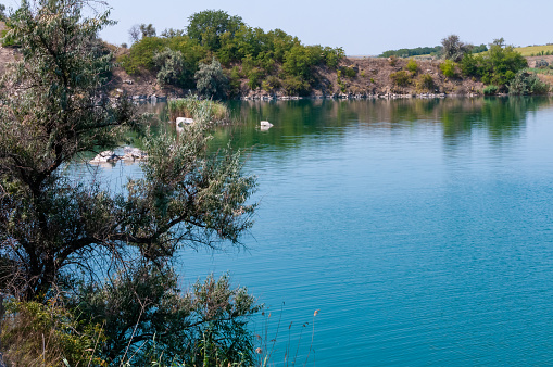 View of the flooded granite quarry with turquoise clear water