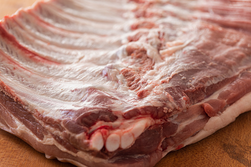 Pork belly with ribs on cutting board, close-up