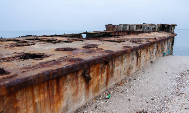 istock Old destroyed concrete barge abandoned on the sandy Kinburn Spit 1945437097