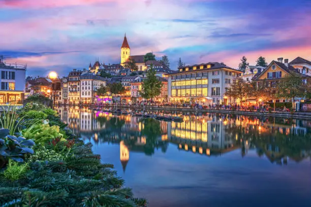 Thun, Switzerland cityscape at twilight.