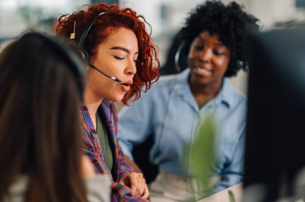 istock Customer services hispanic female agent with headset working in an office 1945498980