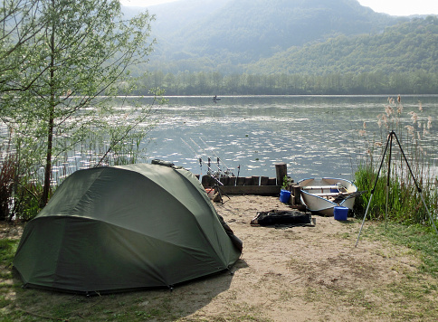 tent of fisherman by the lake while fishing